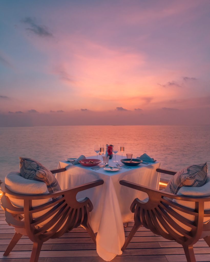 amazing-romantic-couple-dinner-beach-wooden-deck-with-candles-sunset-sky-romance-love